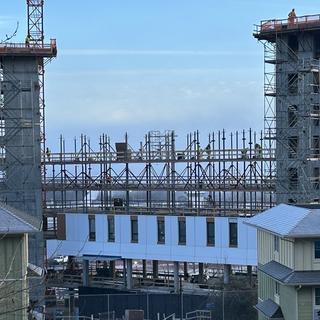 The construction site with existing student housing in front